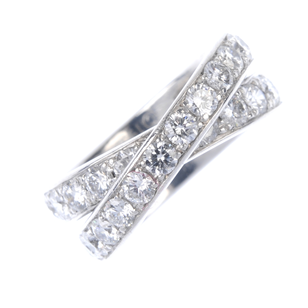 CARTIER - a diamond 'Paris Nouvelle Vague' ring. Comprising two brilliant-cut diamond crossover