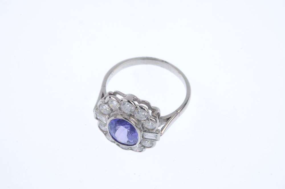 A tanzanite and diamond cluster ring. The oval-shape tanzanite collet, within a brilliant-cut - Image 2 of 4