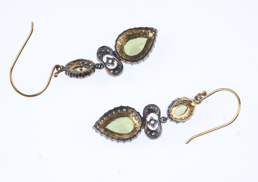 A pair of peridot, seed pearl and diamond ear pendants. Each designed as a pear-shape peridot within - Image 2 of 3