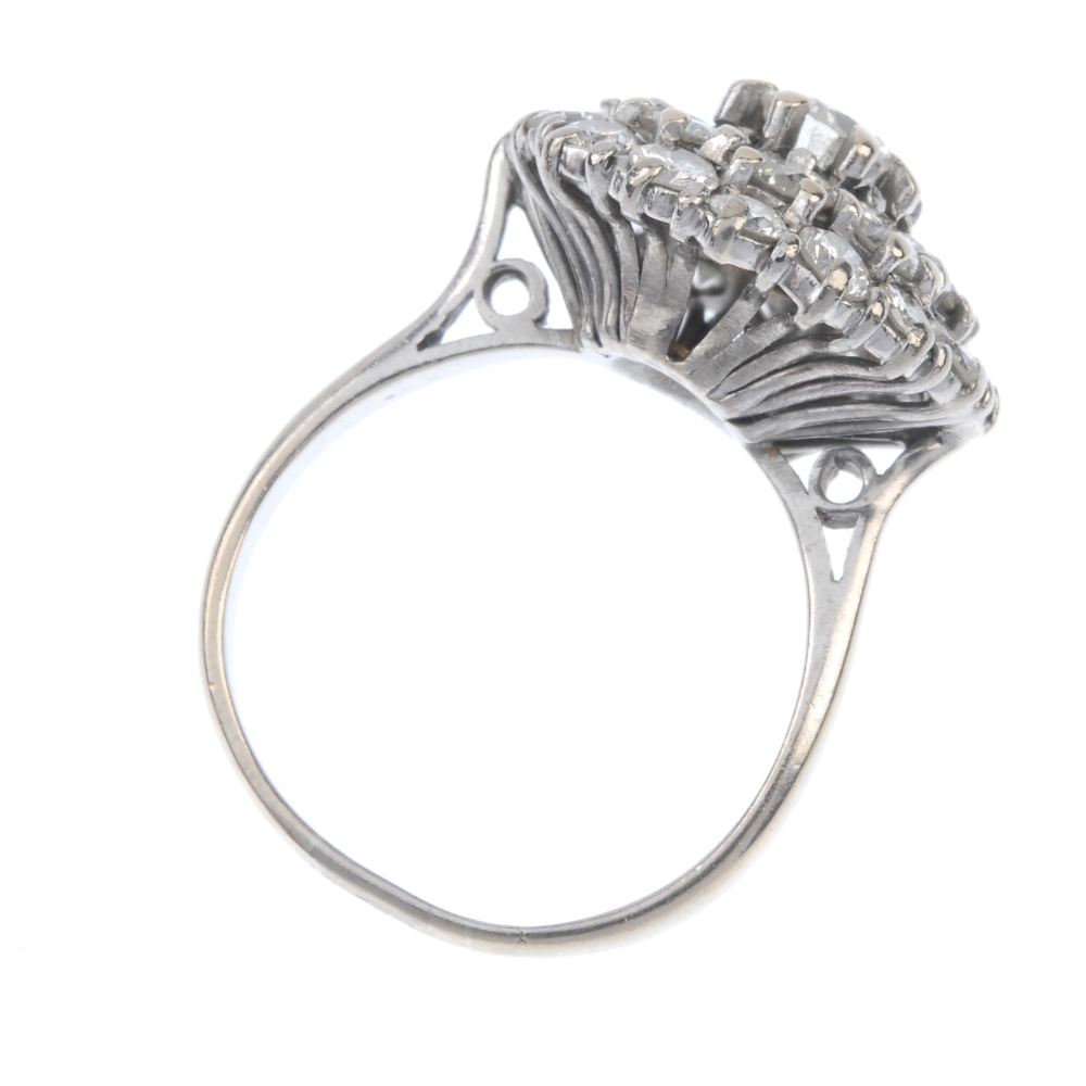 A diamond cluster ring. The brilliant-cut diamond stepped cluster, to the tapered sides and plain - Image 4 of 4