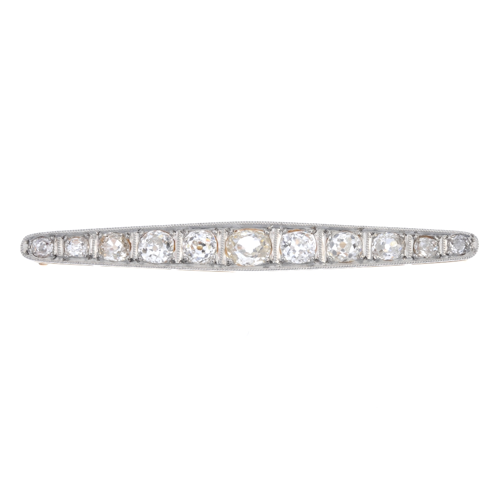 A mid 20th century diamond bar brooch. The graduated old-cut diamond line, within a bi-colour mount.