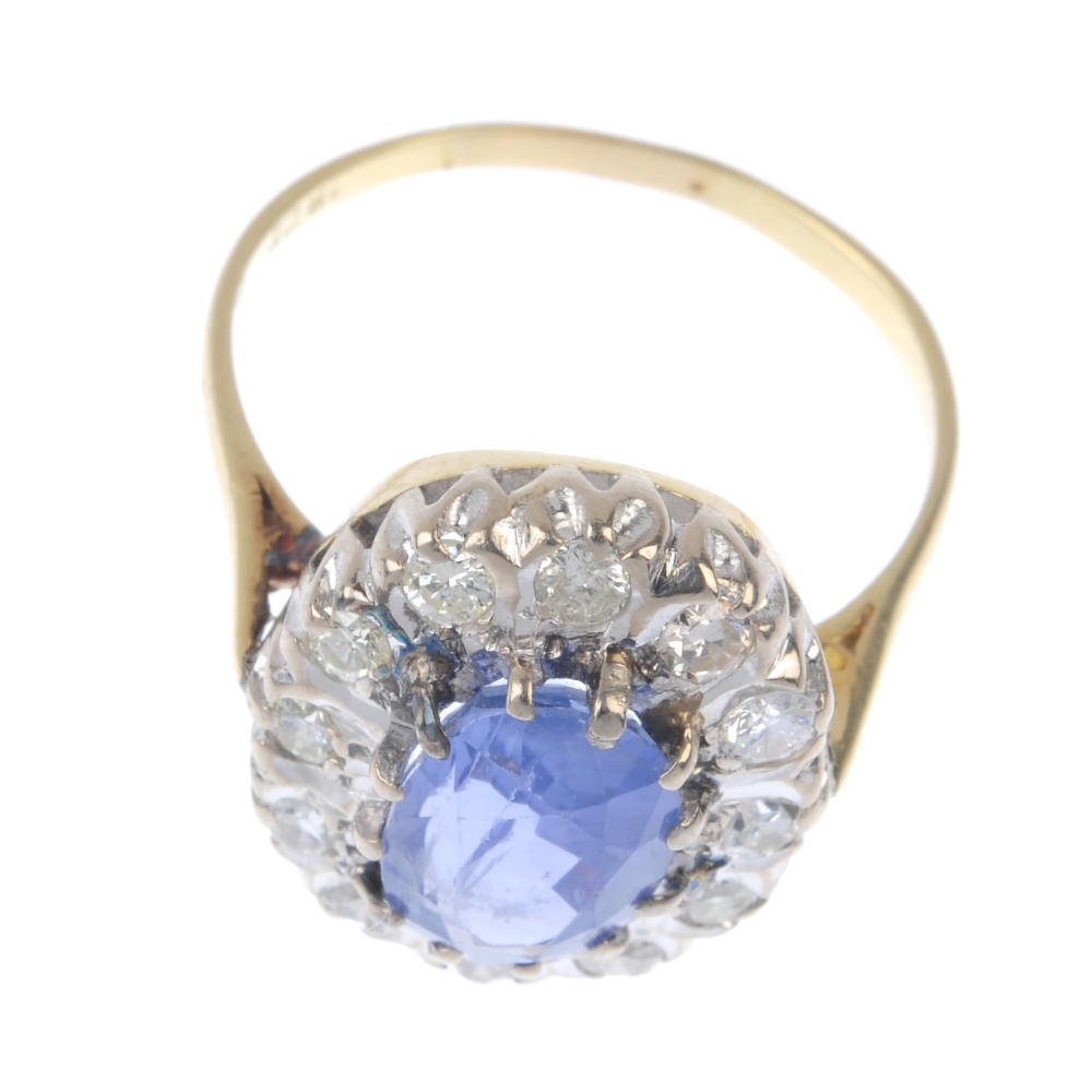 A mid 20th century 18ct gold sapphire and diamond cluster ring. The oval-shape sapphire, within a - Image 2 of 4