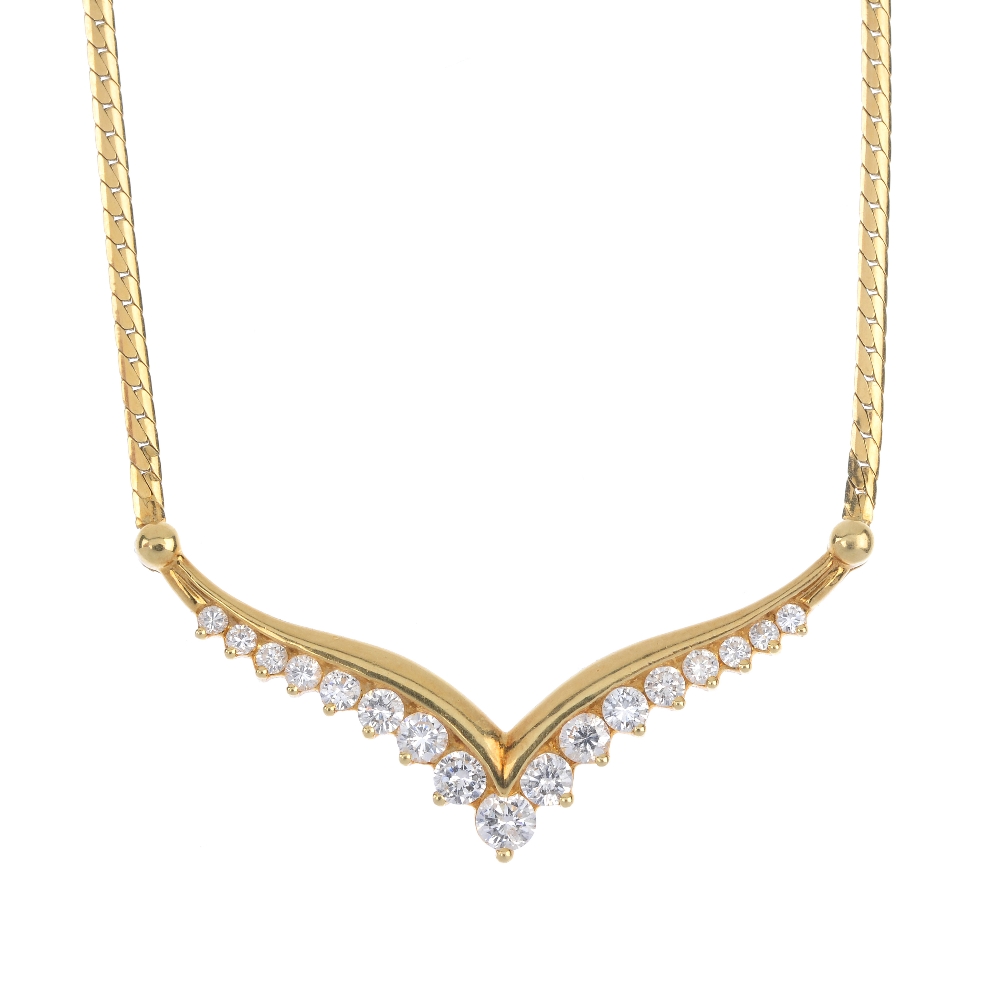 An 18ct gold diamond necklace. The graduated brilliant-cut diamond chevron, to the flattened curb-