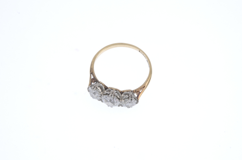 A mid 20th century 18ct gold and platinum diamond three-stone ring. The graduated old-cut - Image 2 of 4