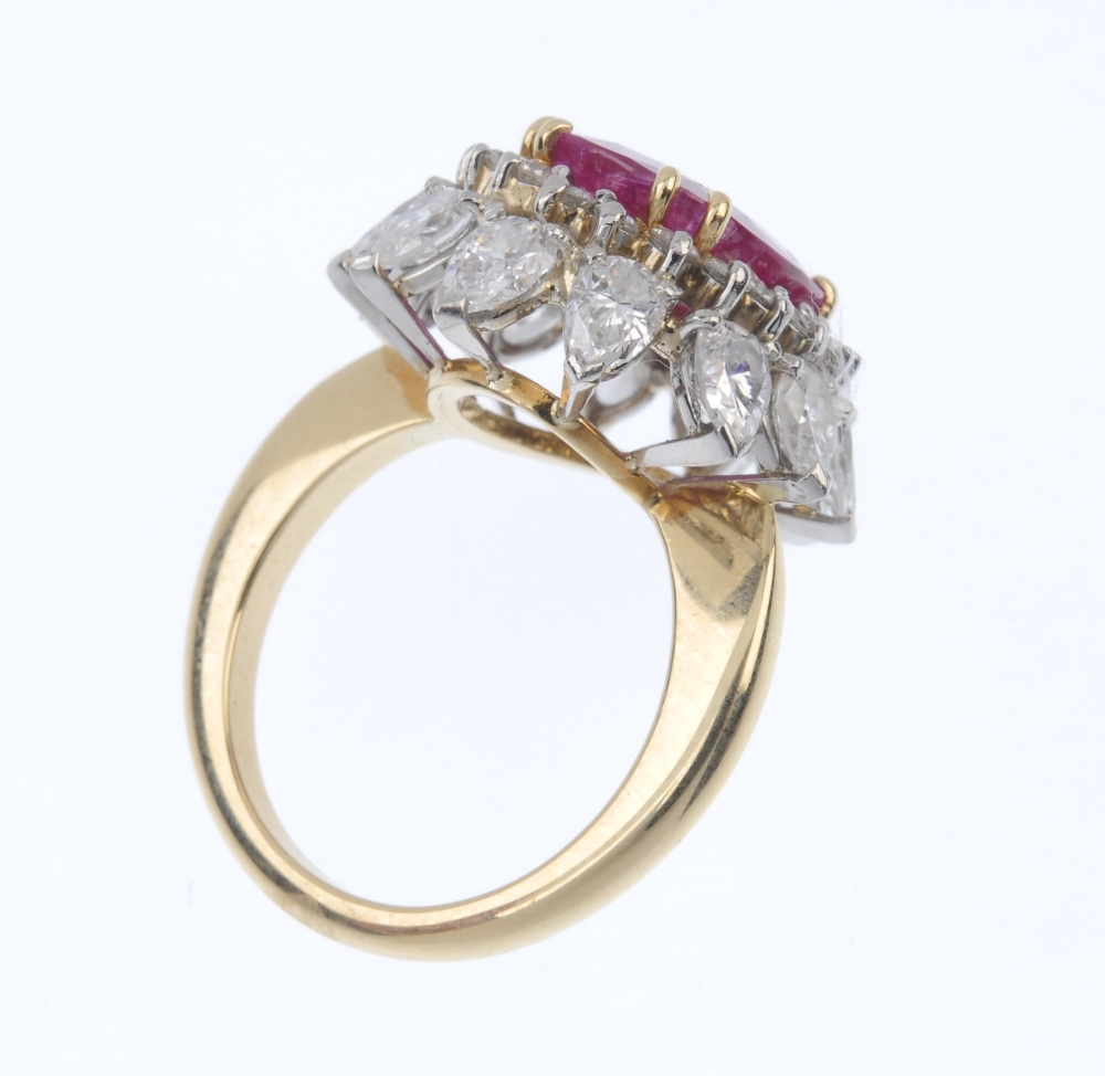 A ruby and diamond floral cluster ring. The oval-shape ruby, within a brilliant-cut diamond - Image 4 of 5