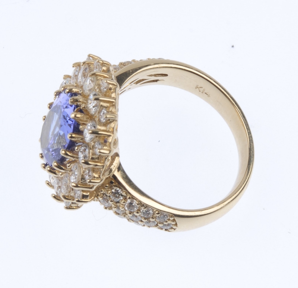 A tanzanite and diamond cluster ring. The oval-shape tanzanite, within a brilliant-cut diamond - Image 3 of 4