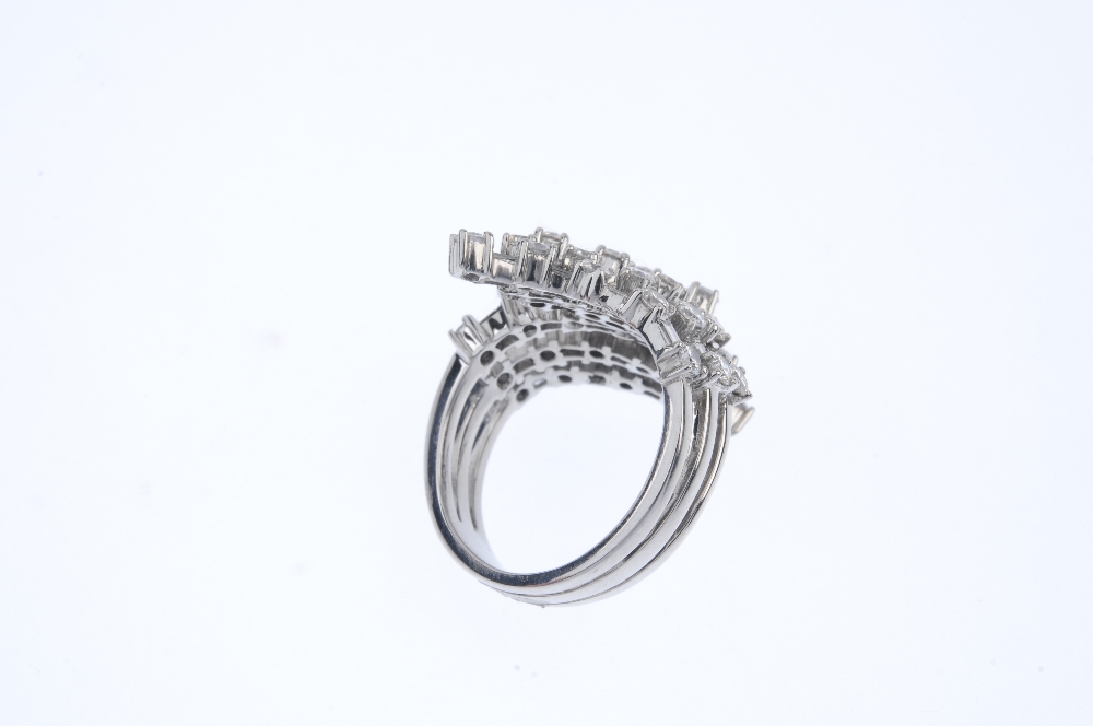A diamond crossover ring. Comprising a stepped series of alternating brilliant and baguette-cut - Image 4 of 4