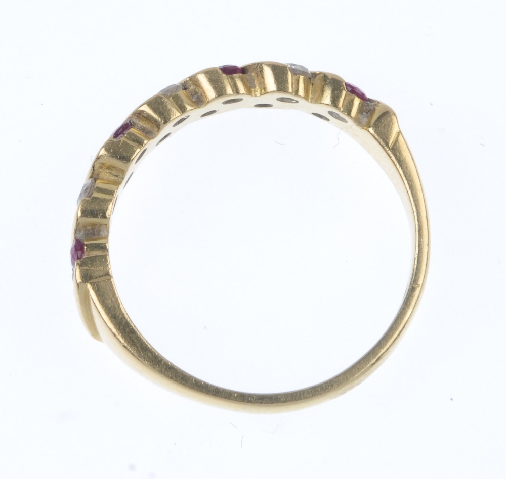 An 18ct gold ruby and diamond ring. Designed as a series of slanted circular-shape ruby pairs, - Image 4 of 4