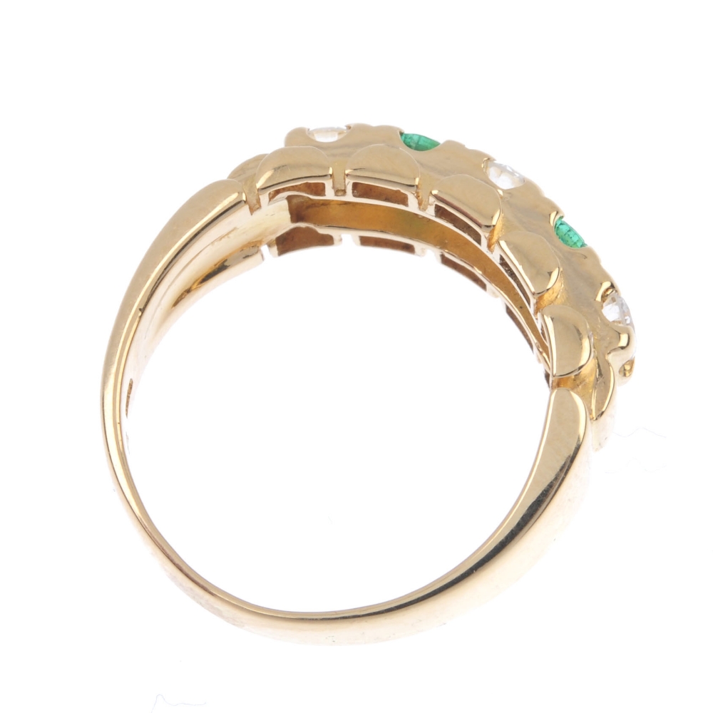 An 18ct gold emerald and diamond dress ring. The alternating brilliant-cut diamond and circular- - Image 4 of 4