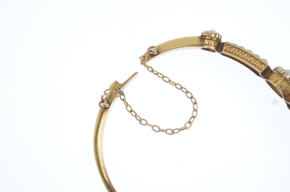 A late 19th century gold split pearl hinged bangle. The front designed as a series of three - Image 3 of 3