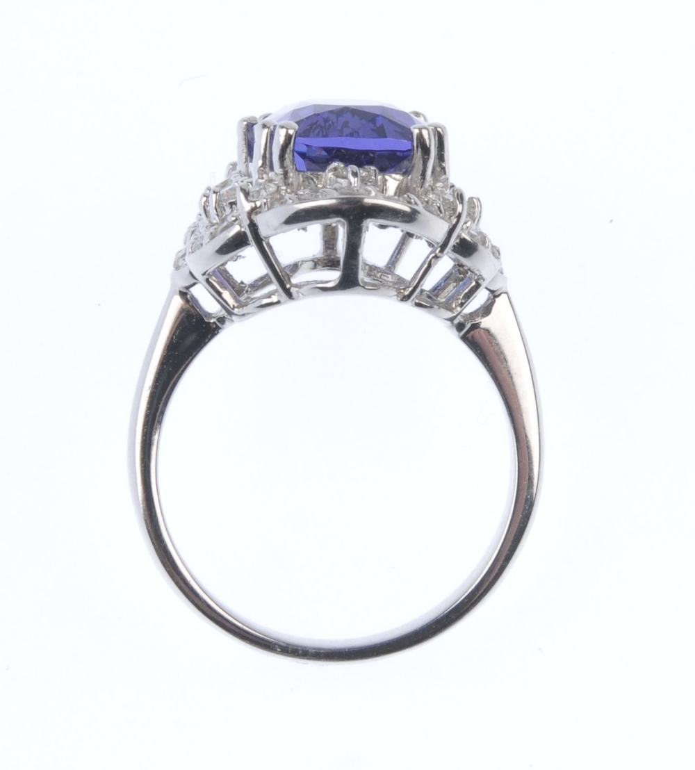 A tanzanite and diamond cluster ring. The oval-shape tanzanite, within a brilliant-cut diamond - Image 2 of 4