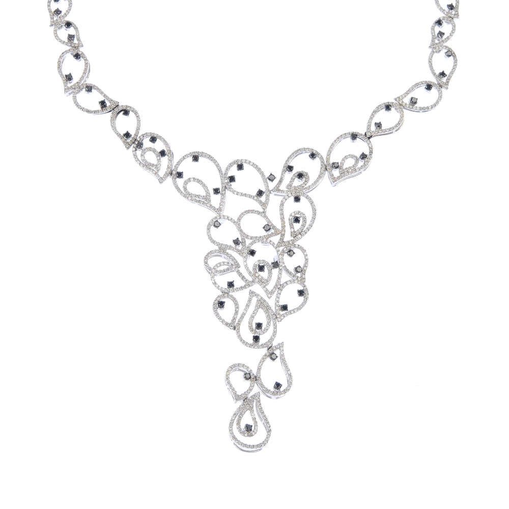 An 18ct gold diamond and gem-set necklace. Of openwork design, the cascade of brilliant-cut