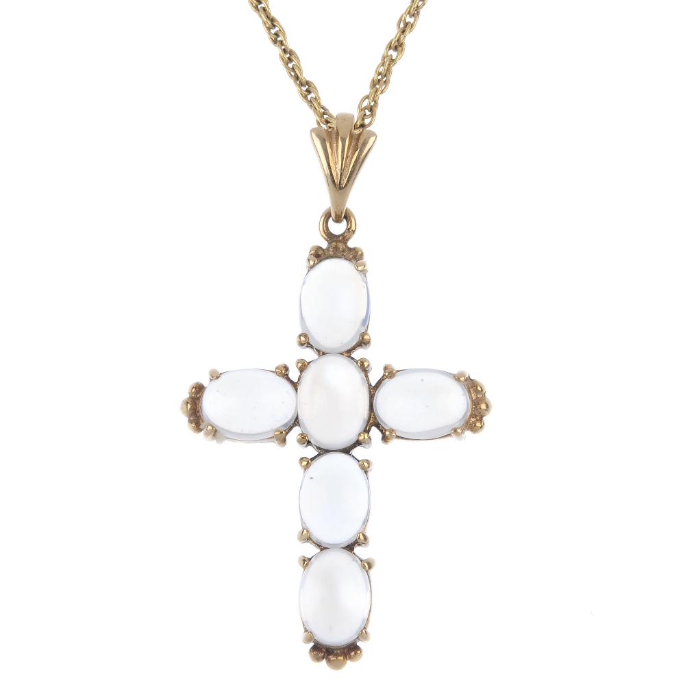 A 9ct gold moonstone cross pendant. The oval moonstone cabochon cross, to the fluted surmount,