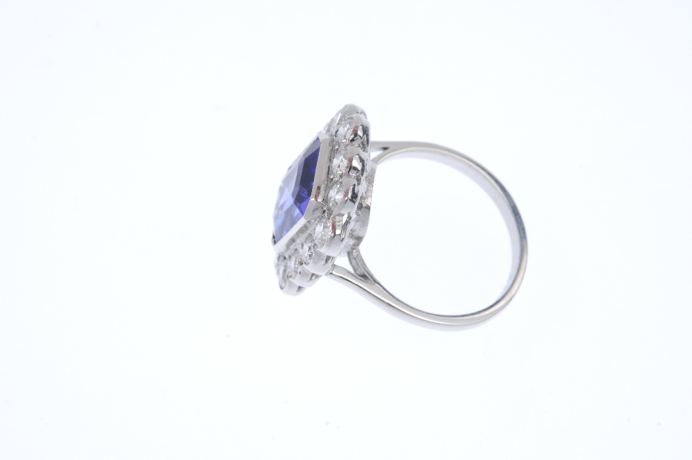 A tanzanite and diamond cluster ring. The rectangular-shape tanzanite collet, within a brilliant-cut - Image 3 of 4