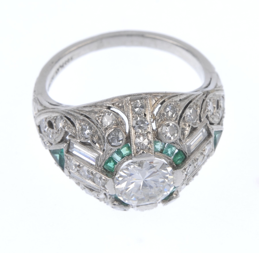 A diamond and emerald dress ring. Of geometric design, the circular-cut diamond, within a calibre- - Image 2 of 4