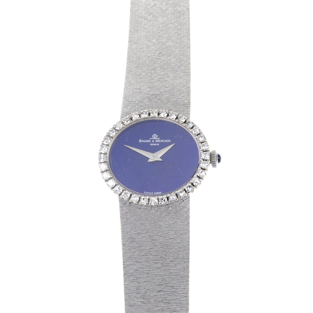 BAUME & MERCIER - an 18ct gold diamond wristwatch. The oval-shape blue dial, within a single-cut