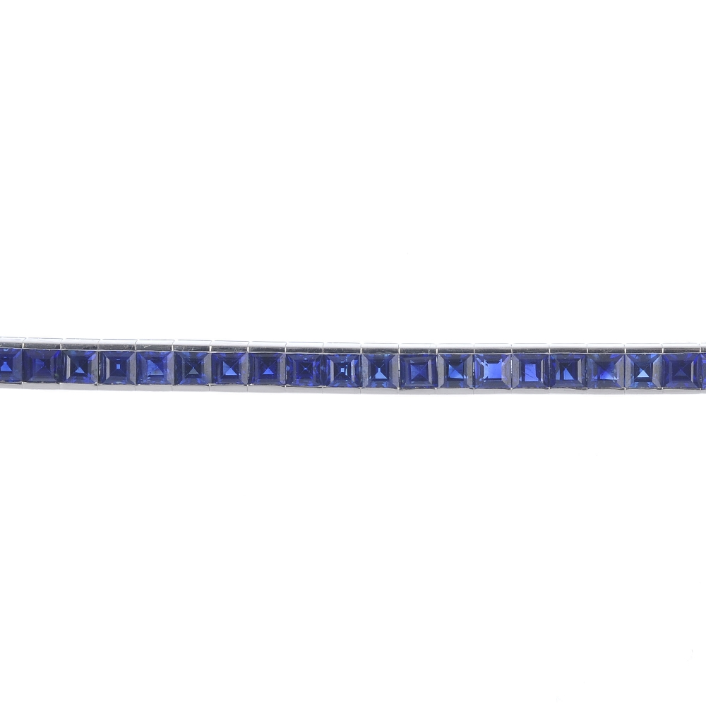 A sapphire bracelet. Designed as a square-shape sapphire line to the partially concealed clasp.