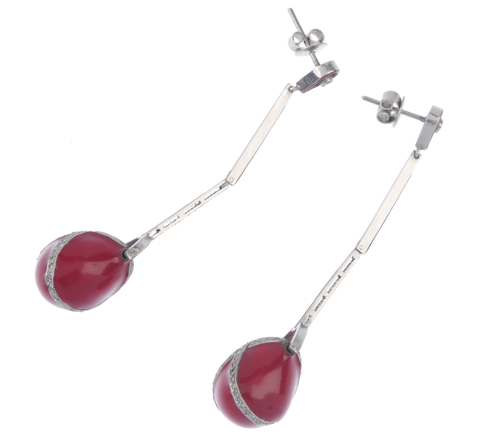 A pair of diamond and enamel ear pendants. The pear-shape red enamel drop, with brilliant-cut - Image 2 of 2