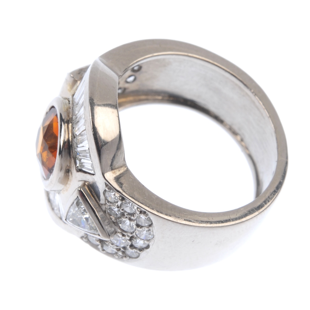 A citrine and diamond dress ring. The circular-shape citrine collet, with tapered baguette-cut and - Image 3 of 4