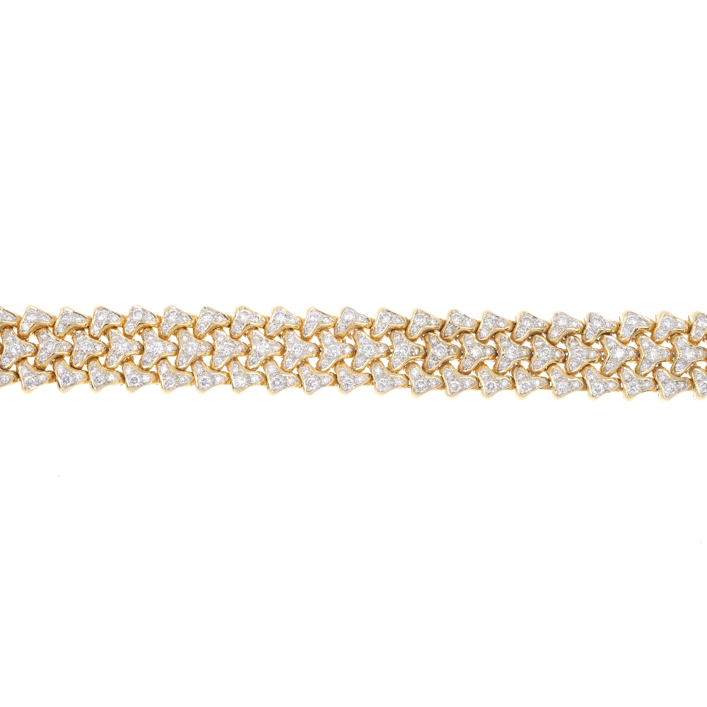 An 18ct gold diamond articulated bracelet. Comprising three rows of pave-set diamond chevron