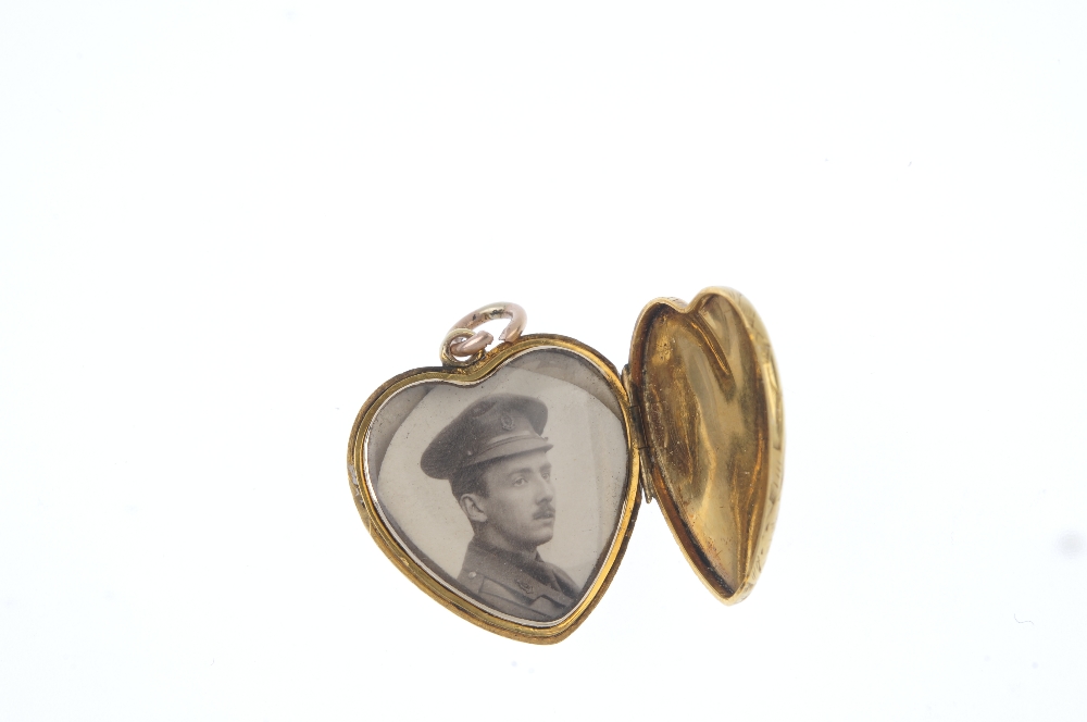 An early 20th century gold heart locket. The scroll engraved front panel, opening to reveal a - Image 3 of 3