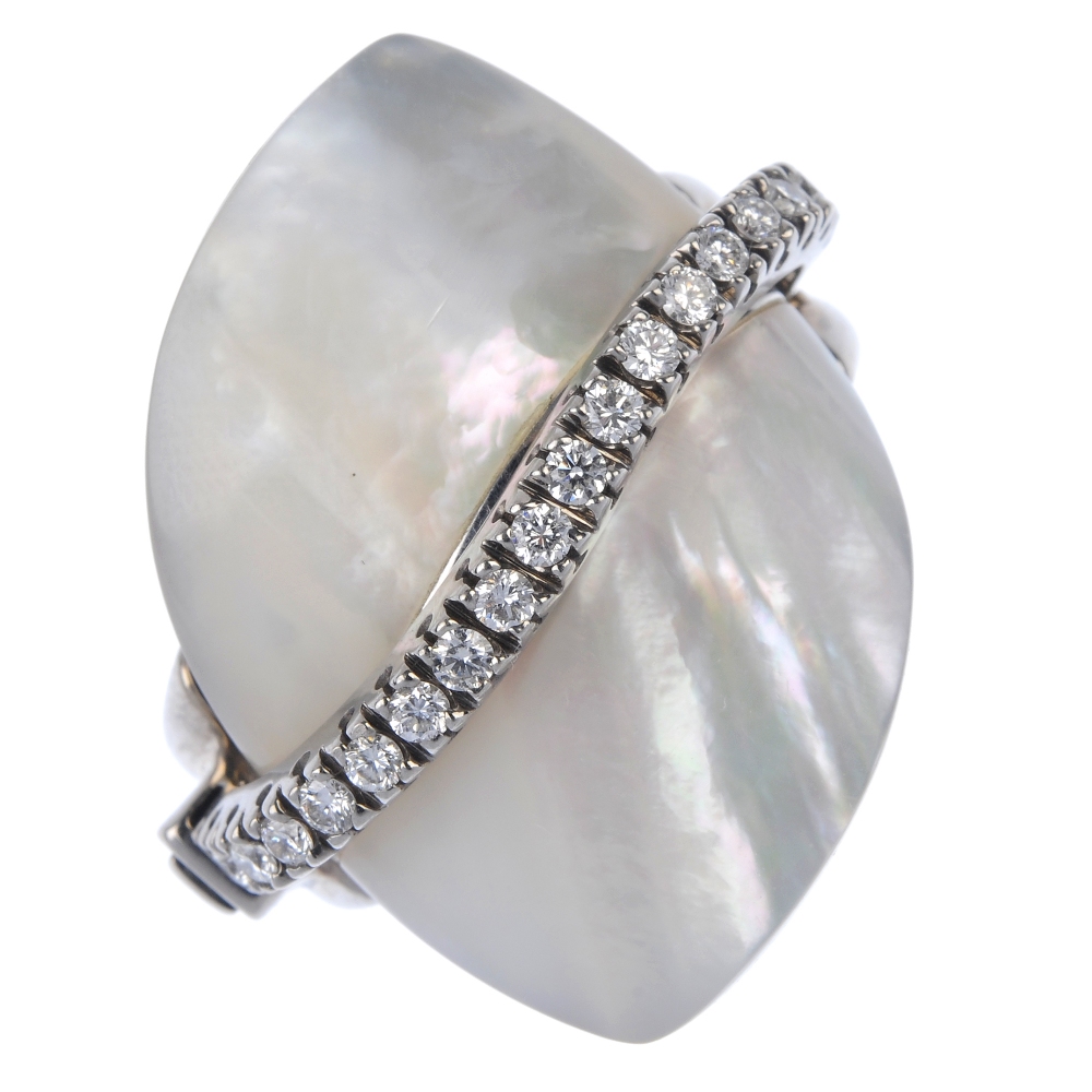 An 18ct gold mother-of-pearl and diamond dress ring. The removable mother-of-pearl panel and