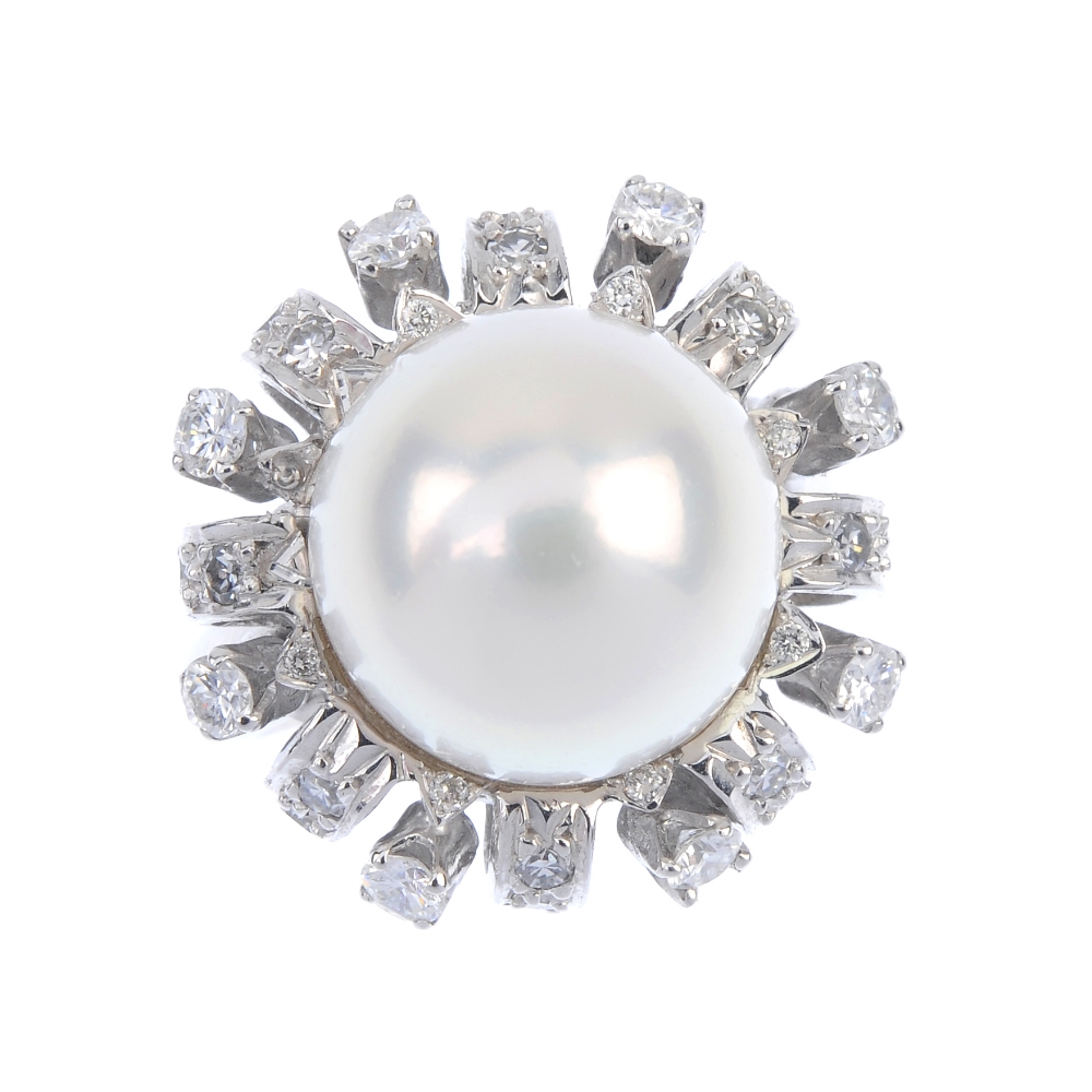 A cultured pearl and and diamond dress ring. The cultured pearl, measuring 12.1mms, within a