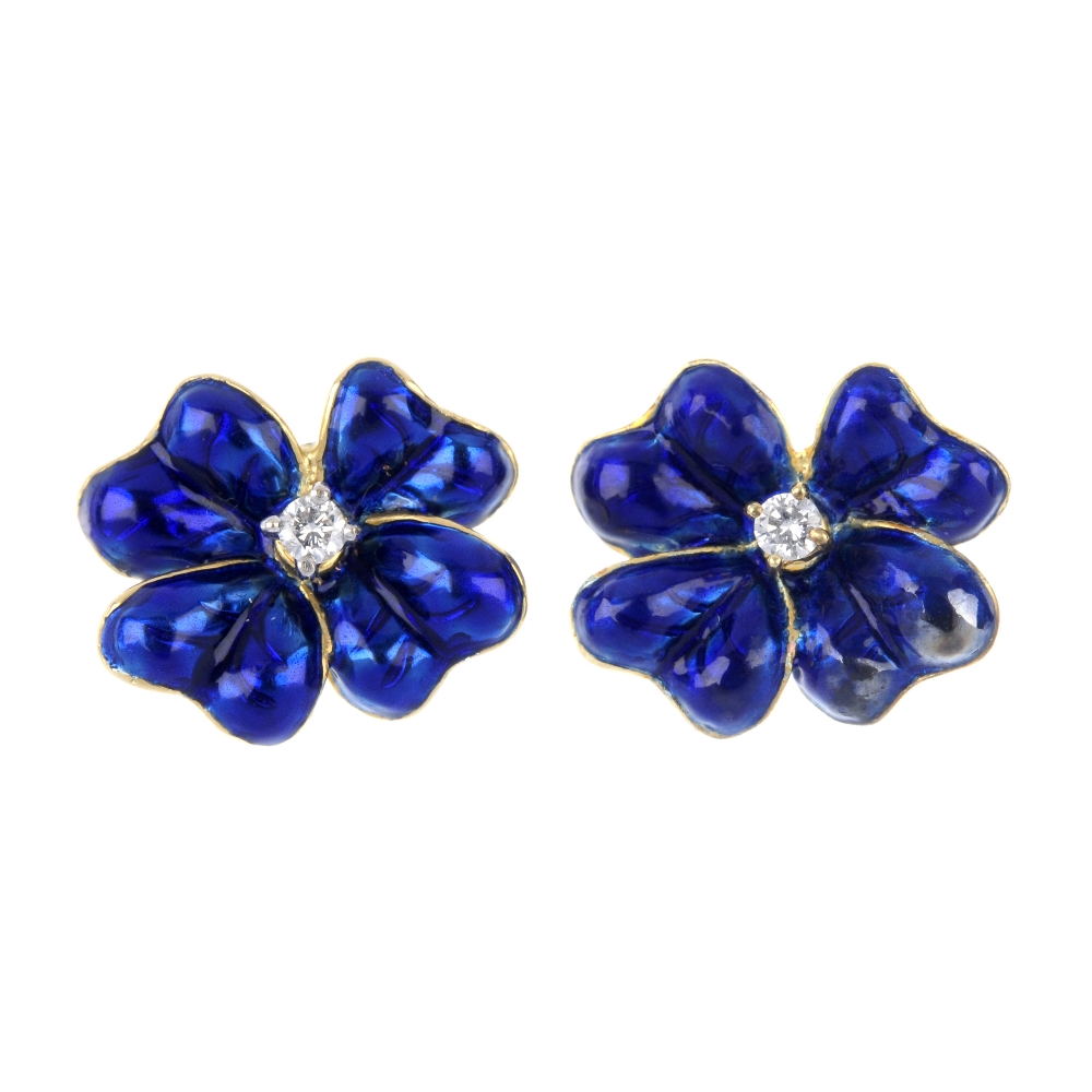 A pair of diamond and enamel floral ear studs. Each designed as a blue enamel flower, with