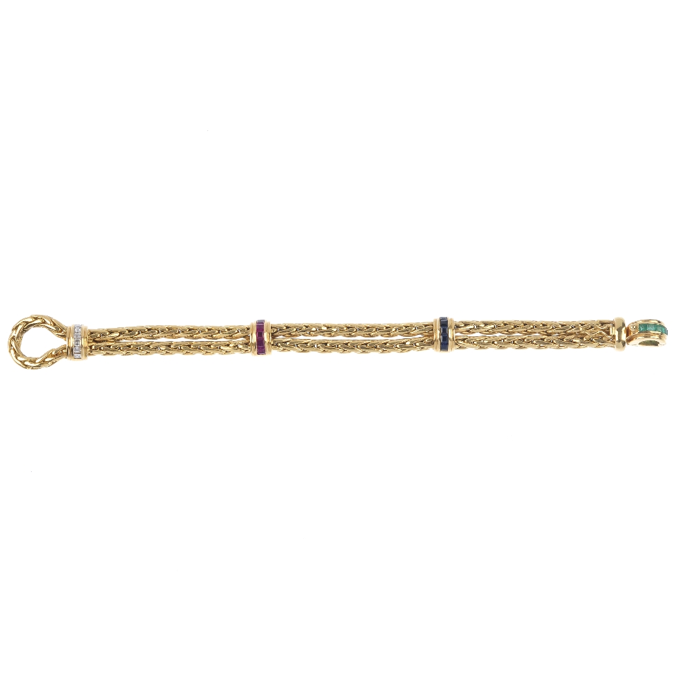 An 18ct gold diamond and gem-set bracelet. The looped rope-twist chain, with calibre-cut sapphire,