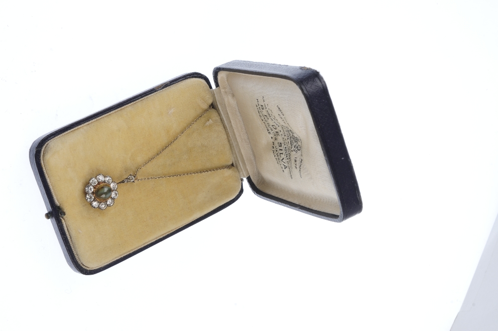 An early 20th century gold cat's-eye chrysoberyl and diamond cluster pendant. The oval cat's-eye - Image 3 of 3