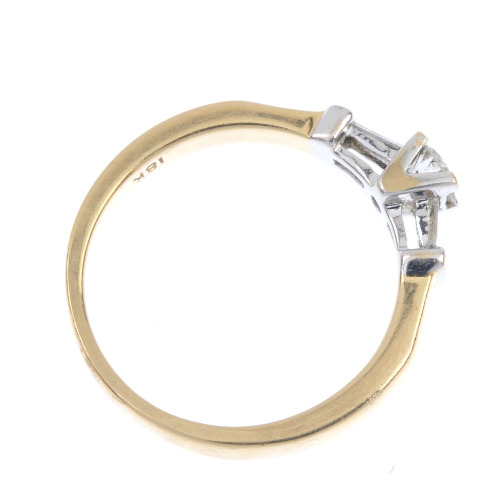 An 18ct gold diamond ring. Of bi-colour design, the brilliant-cut diamond, with baguette-cut diamond - Image 4 of 4
