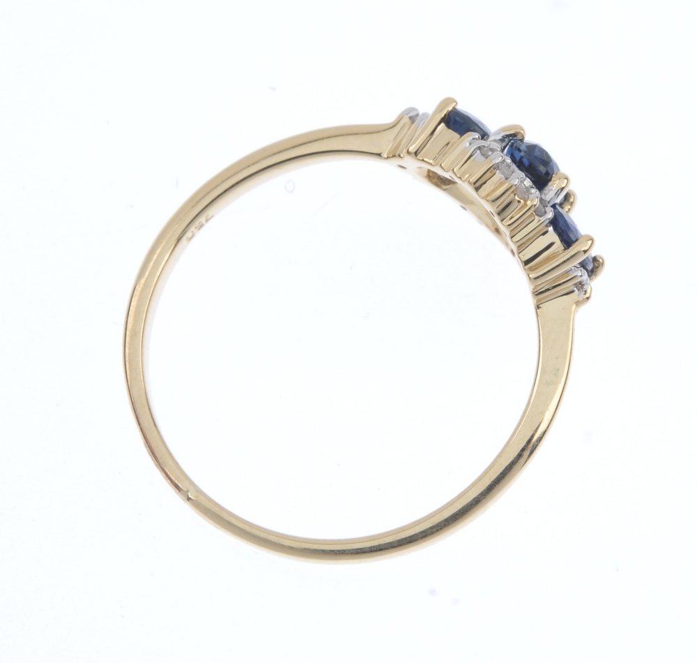 An 18ct gold sapphire and diamond three-stone ring. The slightly graduated oval-shape sapphire line, - Image 4 of 4