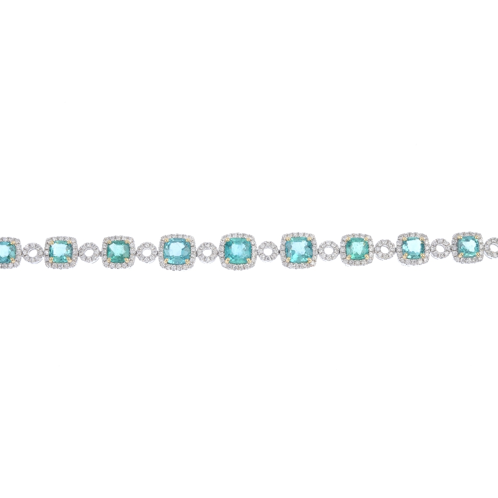 * An emerald and diamond cluster bracelet. Designed as a series of graduated cushion-shape emeralds,