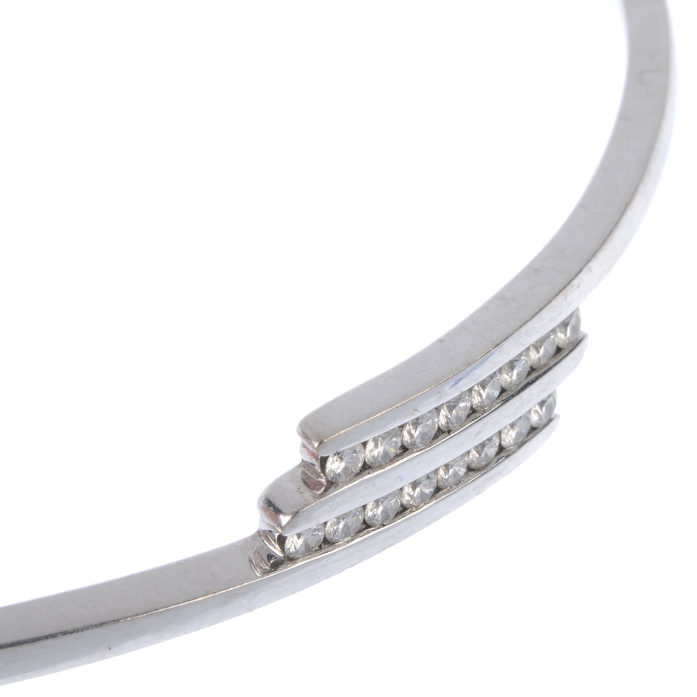 An 18ct gold diamond crossover bangle. Designed as two brilliant-cut diamond diagonal lines, to - Image 2 of 3