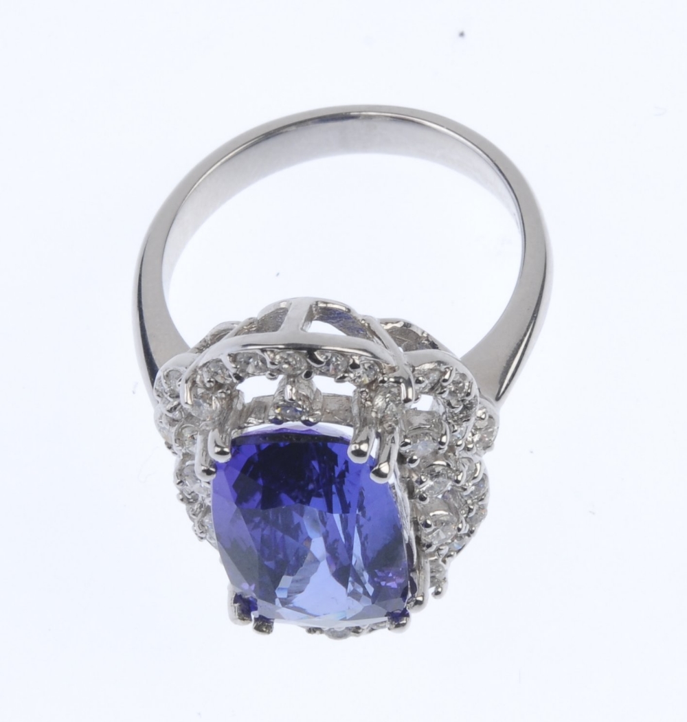 A tanzanite and diamond cluster ring. The oval-shape tanzanite, within a brilliant-cut diamond - Image 3 of 4