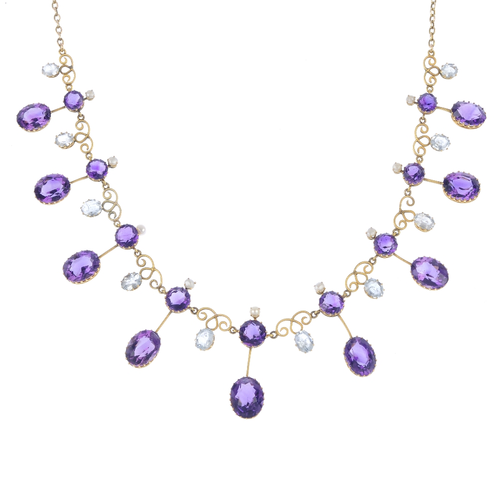An early 20th century gold amethyst and aquamarine fringe necklace. Designed as a graduated series