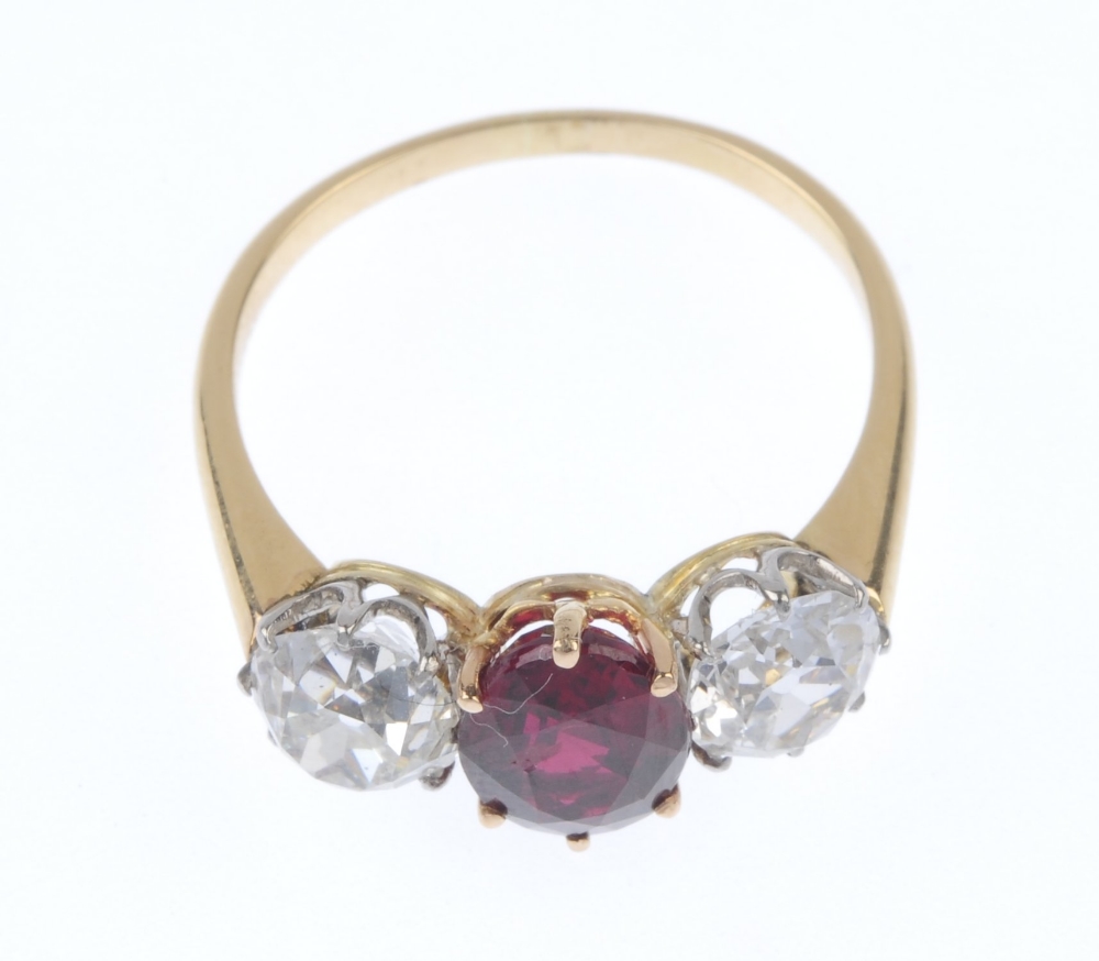 A diamond and ruby three-stone ring. The oval-shape ruby, with old-cut diamond sides, to the plain - Image 2 of 4