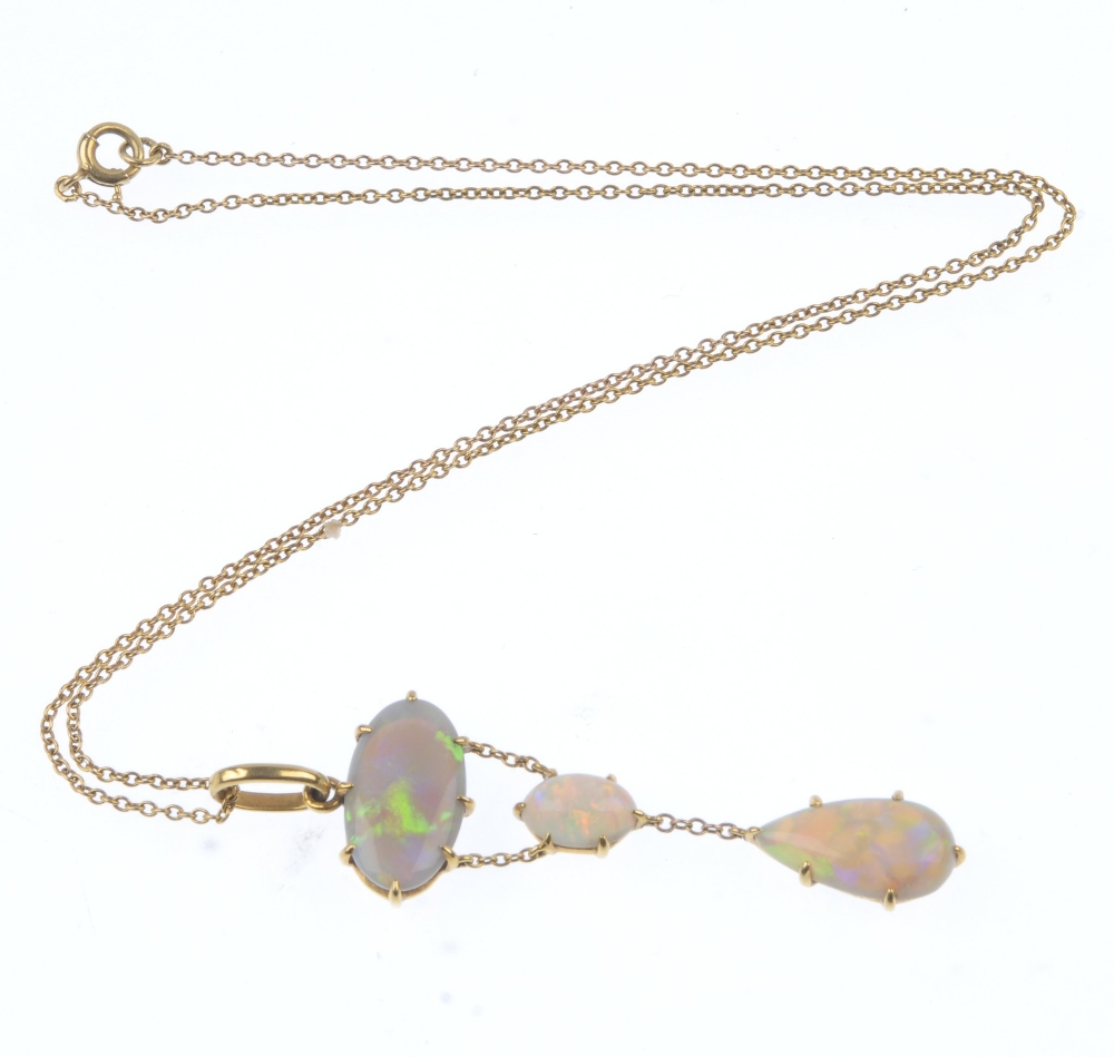 An opal pendant. The pear-shape opal cabochon, suspended from a belcher-link chain, to the oval opal - Image 3 of 3