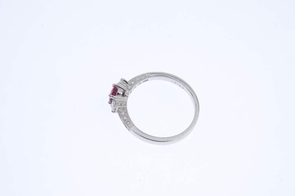 * An 18ct gold ruby and diamond dress ring. The oval-shape ruby and diamond sides, to the baguette- - Image 3 of 4