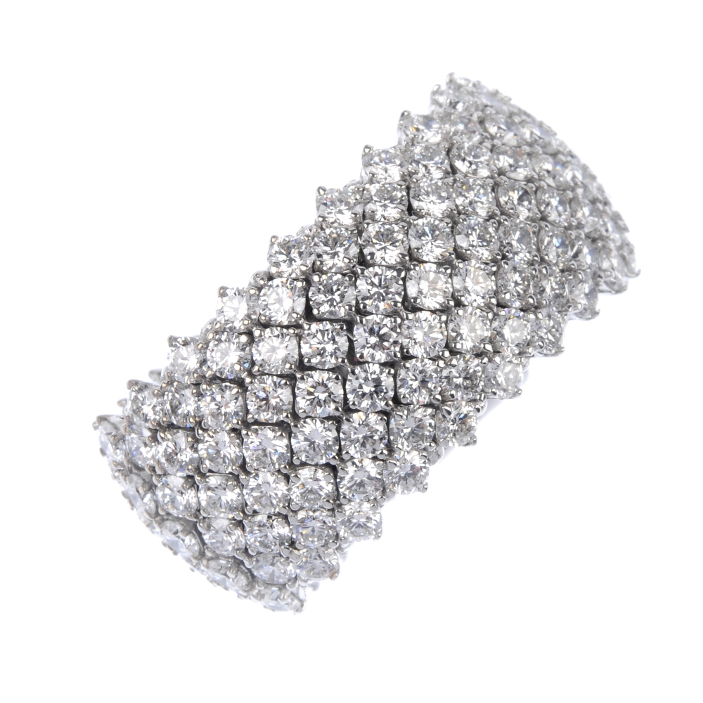 A diamond articulated band ring. Designed as a series of articulated brilliant-cut diamond lines, to