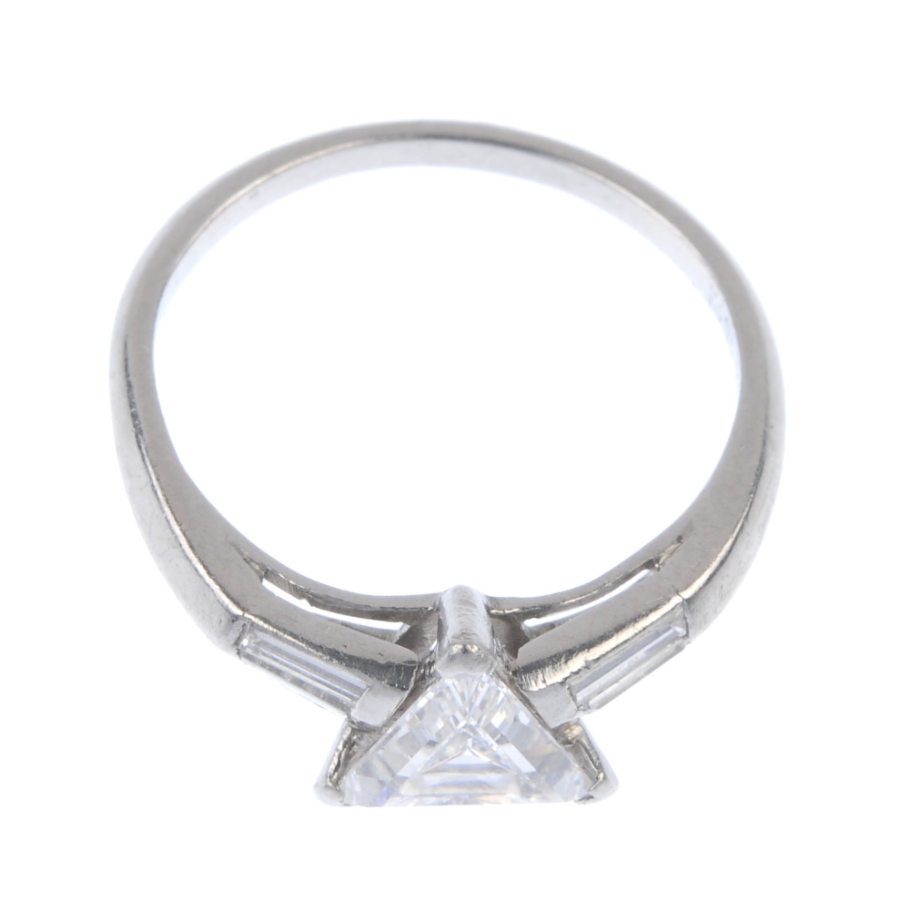 A diamond single-stone dress ring. The triangular-shape diamond, with baguette-cut diamond sides, to - Image 2 of 4