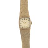 BULOVA - a lady's 1970s 9ct gold watch. The rectangular-shape dial, with hourly applied batons, to