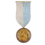 A gold cased silver Masonic steward's jewel. The medal, with personalised mount, suspended from a