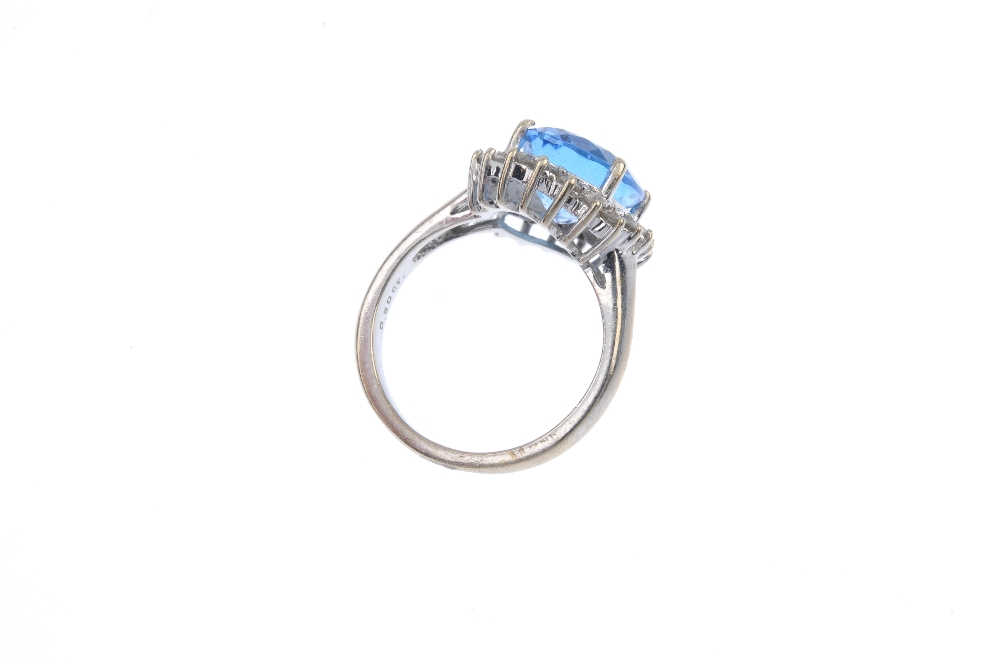 A 9ct gold topaz and diamond cluster ring. The oval-shape blue topaz, within a brilliant-cut diamond - Image 4 of 4