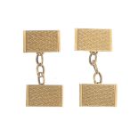 A pair of mid 20th century 9ct gold cufflinks. Each designed as two rectangular-shape engine-