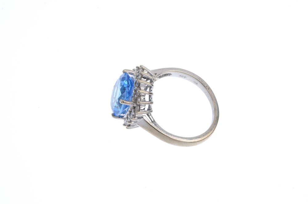 A 9ct gold topaz and diamond cluster ring. The oval-shape blue topaz, within a brilliant-cut diamond - Image 3 of 4