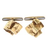 A pair of mid 20th century cufflinks. Each designed as a textured, interlocking cubic panel, to