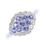 A 9ct gold tanzanite and diamond ring. Of marquise-shape outline, the circular-shape tanzanite