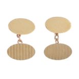 A pair of 9ct gold cufflinks. Each designed as two oval panels, one with grooved line detail,