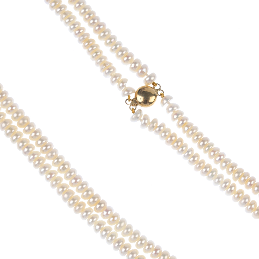 A freshwater cultured pearl two-row necklace. Comprising two strands of button-shape freshwater